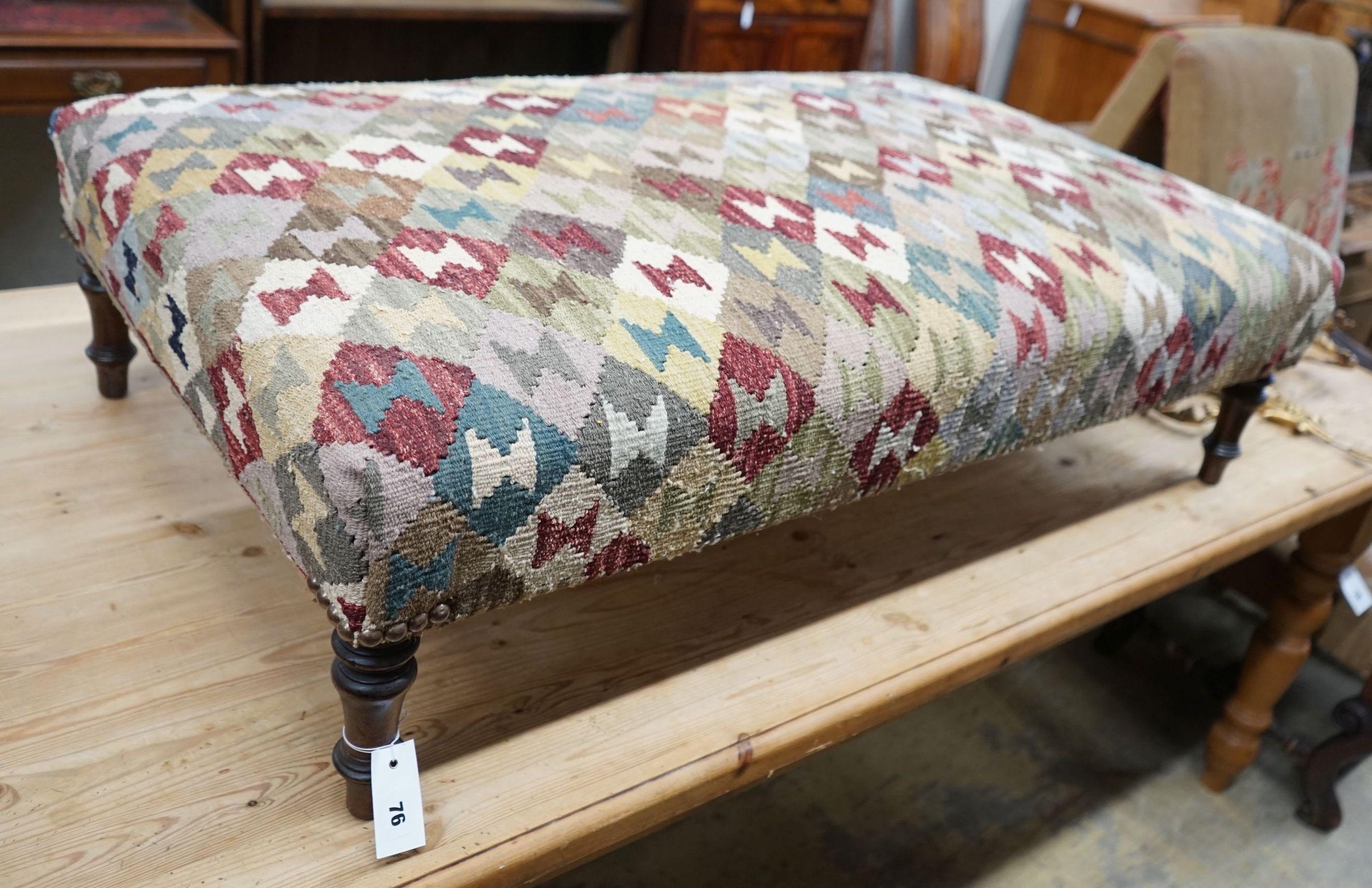 A rectangular polychrome Kelim footstool, length 115cm, depth 70cm, height 33cm